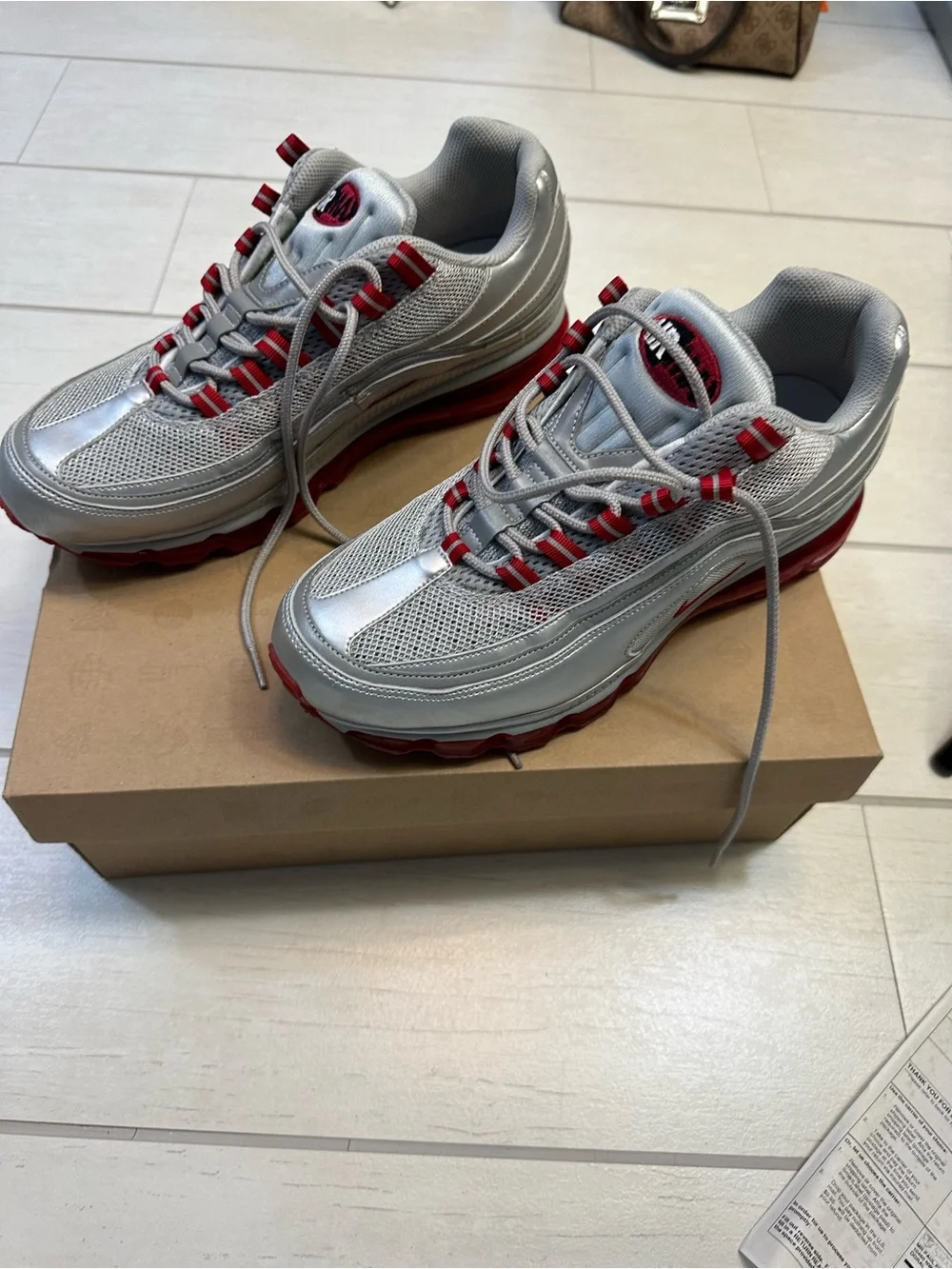 Nike Air Max 24-7 Metallic Silver with Red Accents
